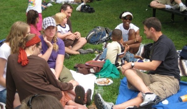 People at a church picnic sitting in the grass