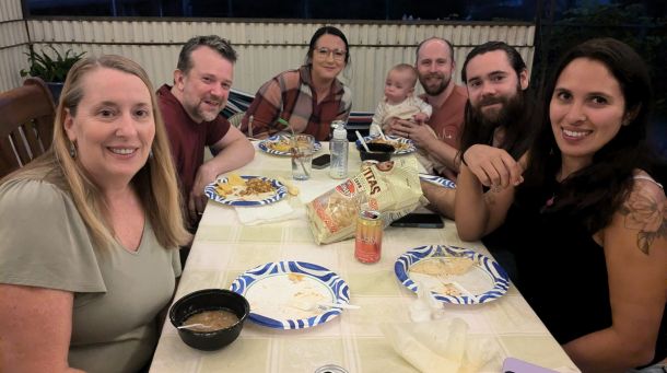 People around a table smiling