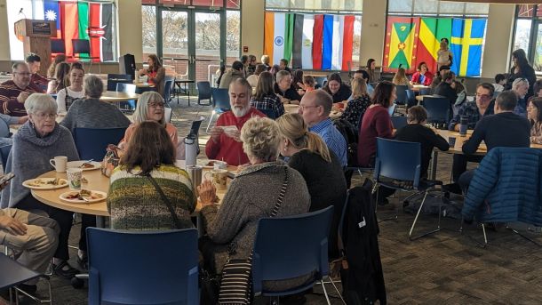 People sitting at round tables eating